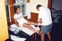 Athletic trainer wrapping a tennis player's ankle